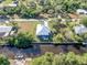 Aerial view of a waterfront home with a metal roof and backyard deck at 28492 Royal Palm Dr, Punta Gorda, FL 33982