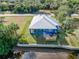 Drone shot of a waterfront home featuring a metal roof and wooden deck at 28492 Royal Palm Dr, Punta Gorda, FL 33982