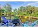 Relaxing deck with fire pit, colorful chairs, and waterfront views at 28492 Royal Palm Dr, Punta Gorda, FL 33982