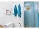 Small bathroom with blue tile shower and wood vanity at 28492 Royal Palm Dr, Punta Gorda, FL 33982