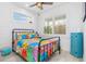 Bright bedroom with a metal bed frame and colorful quilt at 28492 Royal Palm Dr, Punta Gorda, FL 33982