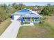 Aerial view of a charming blue house with yellow door at 28492 Royal Palm Dr, Punta Gorda, FL 33982