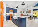 Stylish kitchen featuring a farmhouse sink, blue cabinetry, and orange accents at 28492 Royal Palm Dr, Punta Gorda, FL 33982