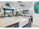 Kitchen island with a farmhouse sink and colorful countertop overlooking the living room at 28492 Royal Palm Dr, Punta Gorda, FL 33982