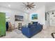 Living room features a green cabinet, blue sofas, and a view to the patio at 28492 Royal Palm Dr, Punta Gorda, FL 33982