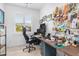 Bright home office featuring a large desk, multiple monitors, and ample storage at 28492 Royal Palm Dr, Punta Gorda, FL 33982