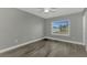 Simple bedroom with ceiling fan and wood-look flooring at 3324 Avanti Cir, North Port, FL 34287