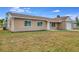 Tan house with white garage door and landscaping at 3324 Avanti Cir, North Port, FL 34287