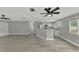 Open living room with modern gray walls and tile floors at 3324 Avanti Cir, North Port, FL 34287