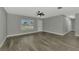 Bright living room with gray walls, tile floor, and large window at 3324 Avanti Cir, North Port, FL 34287