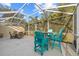 Screened patio with teal chairs and table at 3820 Tripoli Blvd # 42, Punta Gorda, FL 33950