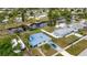 Aerial view of a canal-front home with a blue roof and a blue car in the driveway at 3999 Conway Blvd, Port Charlotte, FL 33952