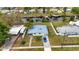 Aerial view showcasing a single-story home with a blue metal roof, situated near a waterway at 3999 Conway Blvd, Port Charlotte, FL 33952