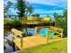 Relaxing dock with teal chairs on calm water at 3999 Conway Blvd, Port Charlotte, FL 33952