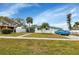 Ranch style home with light green exterior and palm trees at 3999 Conway Blvd, Port Charlotte, FL 33952