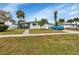 Ranch style home with light green exterior and palm trees at 3999 Conway Blvd, Port Charlotte, FL 33952