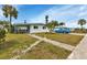 Ranch-style home with light green exterior and driveway at 3999 Conway Blvd, Port Charlotte, FL 33952