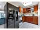 Kitchen with black refrigerator and wood cabinets at 3999 Conway Blvd, Port Charlotte, FL 33952