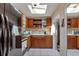 Galley kitchen with wood cabinets and skylights at 3999 Conway Blvd, Port Charlotte, FL 33952