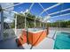 Hot tub with wooden steps and screened enclosure at 4132 Michel Tree St, Port Charlotte, FL 33948