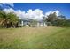 Single-story home with solar panels and a porch at 4132 Michel Tree St, Port Charlotte, FL 33948