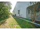 Exterior view of the house showcasing landscaping and a side entrance at 4132 Michel Tree St, Port Charlotte, FL 33948