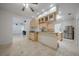 Kitchen with island, stainless steel appliances, and light wood cabinets at 4132 Michel Tree St, Port Charlotte, FL 33948