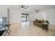 Bright living room with tiled floors, sliding doors to pool area, and ceiling fans at 4132 Michel Tree St, Port Charlotte, FL 33948