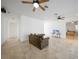 Living room with tiled floors, ceiling fans, and access to other rooms at 4132 Michel Tree St, Port Charlotte, FL 33948