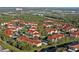 Aerial view of a residential neighborhood featuring red-tiled roofs and lush green trees at 4178 Central Sarasota Pkwy # 326, Sarasota, FL 34238