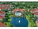 Beautiful aerial view of a community clubhouse, pool, and lake with fountain at 4178 Central Sarasota Pkwy # 326, Sarasota, FL 34238