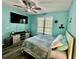 Nautical themed bedroom with a ceiling fan, TV, and natural light from the window at 4178 Central Sarasota Pkwy # 326, Sarasota, FL 34238