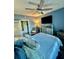 Bedroom with ceiling fan, TV, coastal decor, and ensuite bath/closet at 4178 Central Sarasota Pkwy # 326, Sarasota, FL 34238