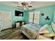 Bright nautical themed bedroom with TV, ceiling fan, and natural light from window at 4178 Central Sarasota Pkwy # 326, Sarasota, FL 34238