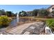 Relaxing pool deck with lounge chairs overlooking a serene lake and fountain feature at 4178 Central Sarasota Pkwy # 326, Sarasota, FL 34238