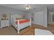 Bedroom with white bed frame, coral bedding, and double door closet at 4315 Cape Haze Dr, Placida, FL 33946