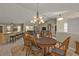 Open concept dining room with a chandelier and views to the kitchen at 4315 Cape Haze Dr, Placida, FL 33946