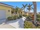 Landscaped walkway leading to a charming yellow house at 4315 Cape Haze Dr, Placida, FL 33946