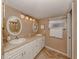 Bathroom with double vanity, updated lighting and tiled floors at 437 Cerromar Ln # 312, Venice, FL 34293