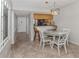 Bright dining area with white table and chairs, and kitchen views at 437 Cerromar Ln # 312, Venice, FL 34293