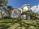 Two-story condo building with lush landscaping and a tranquil lawn at 437 Cerromar Ln # 312, Venice, FL 34293