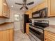 Kitchen with wood cabinets, stainless steel appliances, and granite countertops at 437 Cerromar Ln # 312, Venice, FL 34293