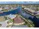 Aerial view of a waterfront home with a private dock, lush landscaping, and easy access to the serene waters at 500 Andora Dr, Punta Gorda, FL 33950