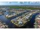 Serene aerial view of waterfront home nestled among palm trees, offering canal access and a picturesque setting at 500 Andora Dr, Punta Gorda, FL 33950