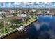 Backyard aerial featuring a boat dock with boat lift, waterfront access and screen enclosed pool at 500 Andora Dr, Punta Gorda, FL 33950