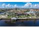 Aerial shot of the waterfront backyard with a boat dock, and a screened-in pool, perfect for entertaining at 500 Andora Dr, Punta Gorda, FL 33950