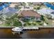 Aerial view of the screened in pool and dock, situated directly on a canal for boating and water activities at 500 Andora Dr, Punta Gorda, FL 33950