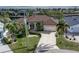 Aerial front view of home with a tile roof, arched entryway, attached garage and landscaped front yard at 500 Andora Dr, Punta Gorda, FL 33950