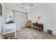 Bright bedroom with a ceiling fan, comfy chair, and ample natural light at 101 N Marion Ct # 133, Punta Gorda, FL 33950