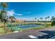 Community tennis court with green surface, surrounded by palm trees and lush landscaping at 101 N Marion Ct # 133, Punta Gorda, FL 33950